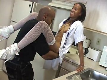 Hot black nurse gets her pussy slammed on table